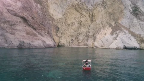 Man with a briefcase fixing up his suit on a boat in the middle of the ocean Stock-Footage 77927074