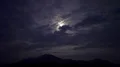 The man with a bright firework stick running on a night mountain 4k or 4k+ Resolution