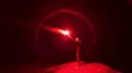 The man with a bright firework stick standing outdoor 4k or 4k+ Resolution