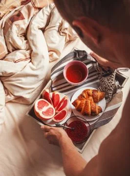 Man bring breakfast in bed Stock Photos