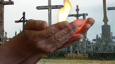 Man bringing fire burning in arms with Crosses background Stock Footage 68390901