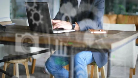 Man bringing hands to laptop and typing for work in tech space, animated gears Stock Footage 334113861
