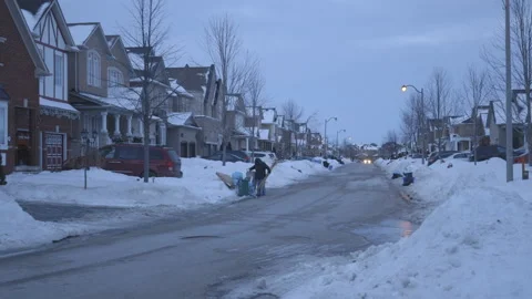 Man Bringing out Garbage on Suburban Street during the Winter Stock-Footage 147689670