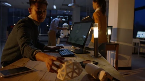Man brings 3D printed part to his colleague's robot at modern office Video stock 106777066