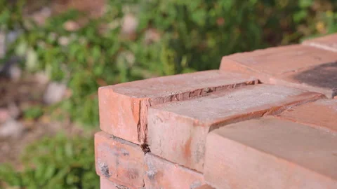 Man brings bricks for construction to store on brick stack Stock Footage 258310815