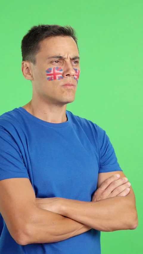 Man with british flag painted looking away with serious expression Stock Footage 260114035