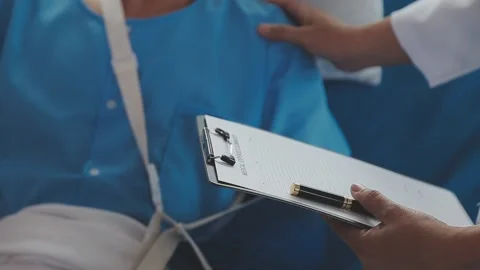Man with broken arm in cast lying on bed in hospital. The emergency center .. Stock Footage 237335835