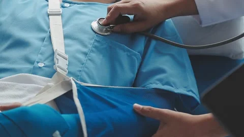 Man with broken arm in cast lying on bed in hospital. The emergency center .. Stock Footage 237335837