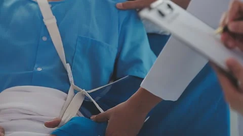 Man with broken arm in cast lying on bed in hospital. The emergency center .. Stock Footage 237335842