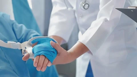 Man with broken arm in cast lying on bed in hospital. The emergency center .. Stock Footage 237335857