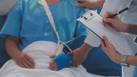 Man with broken arm in cast lying on bed in hospital. The emergency center .. Stock Footage 237335858