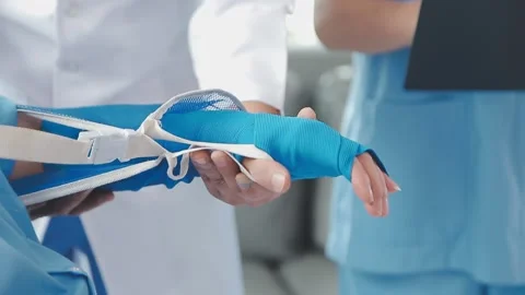 Man with broken arm in cast lying on bed in hospital. The emergency center .. Stock Footage 237335859