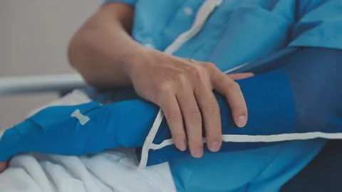Man with broken arm in cast lying on bed in hospital. The emergency center .. Stock Footage 237335864