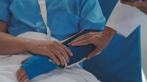 Man with broken arm in cast lying on bed in hospital. The emergency center .. Stock Footage 237335885