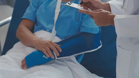 Man with broken arm in cast lying on bed in hospital. The emergency center .. Stock Footage 237335890