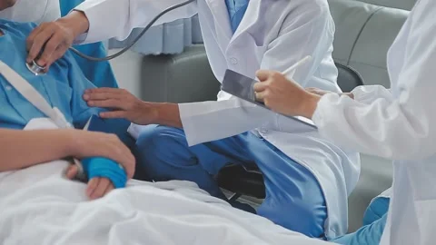 Man with broken arm in cast lying on bed in hospital. The emergency center .. Stock Footage 237335903