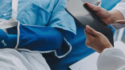 Man with broken arm in cast lying on bed in hospital. The emergency center .. Stock Footage 237356785