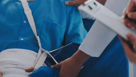 Man with broken arm in cast lying on bed in hospital. The emergency center .. Stock Footage 237356793