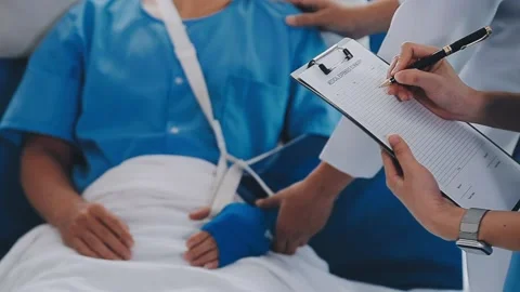 Man with broken arm in cast lying on bed in hospital. The emergency center .. Stock Footage 237356794