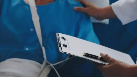 Man with broken arm in cast lying on bed in hospital. The emergency center .. Stock Footage 237356795
