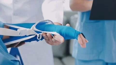 Man with broken arm in cast lying on bed in hospital. The emergency center .. Stock Footage 237356797