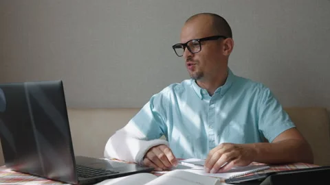 Man with broken arm having online meeting Stock Footage 158686364