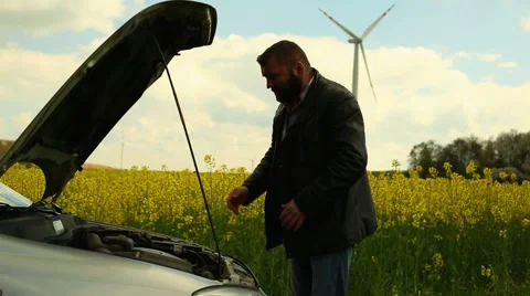 Man with broken car in countryside Stock Footage 62861864