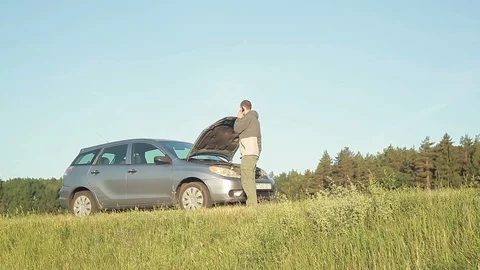 Man with broken down car on side of road Stock Footage 94562543