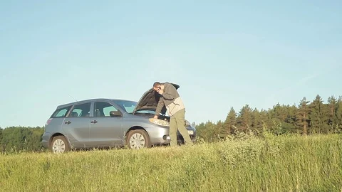 Man with broken down car on side of road Stock Footage 95222324