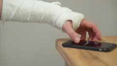 Male Hand, Wrapped In A Plaster Cast, Scrolls Through A Touchscreen On A  Mobile Phone. Unrecognizable Man In Black T-shirt With Broken Wrist Surfs  The Internet At Home Stock Photo, Picture and