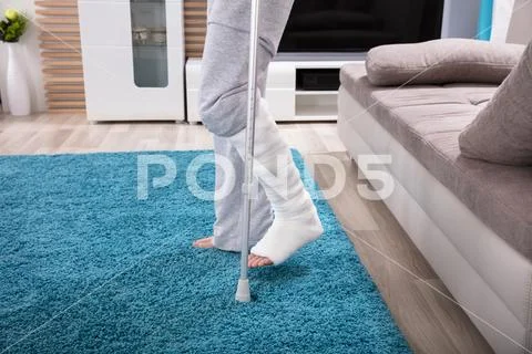 Man With Broken Leg Walking On Carpet Stock Photos