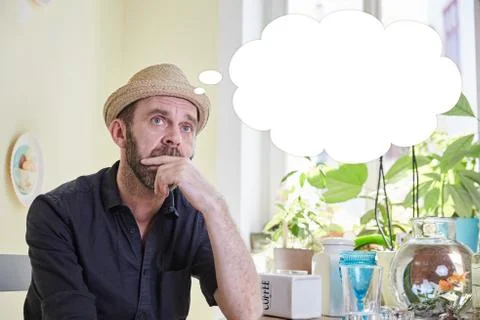 Man brooding with a thought bubble over his head Stock Photos