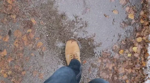Man in Brown Boots Walks in a Puddle of Water Stock Footage 57644553