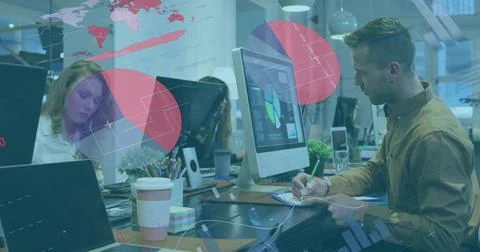 Man in brown button-down shirt writing notes at office desk, with laptop coffee Stock Photos