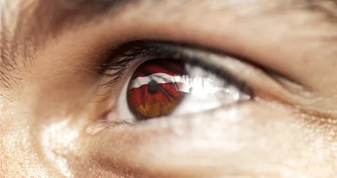 Man brown eye in close up with the flag of latvia in iris with wind motion. vide Video stock 120816770