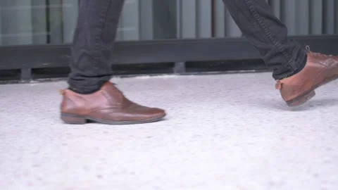Man with brown shoes walking Stock Footage 147106094
