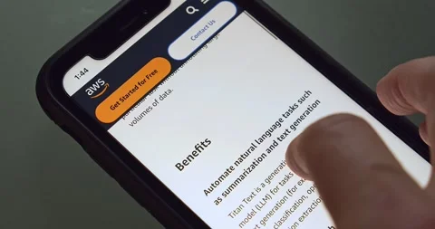 Man browses Amazon Titan (Amazon Titan FMs) website seen in an iPhone screen 動画素材 241699062