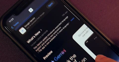 Man browses Google Gemini app page in the App Store Stock Footage 296472045