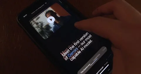 Man browses Google Gemini website seen in an iPhone screen Stock Footage 257763981