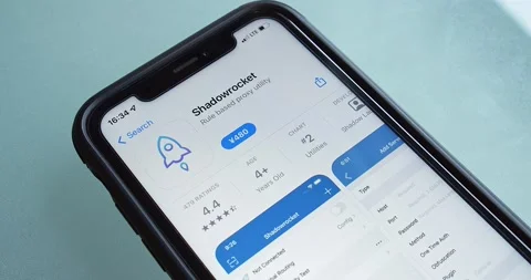 Man browses Shadowrocket app page in App Store on iPhone Stock Footage 238649121