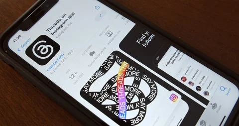 Man browses Threads app page seen in App Store on an iPhone Stock Footage 245417722