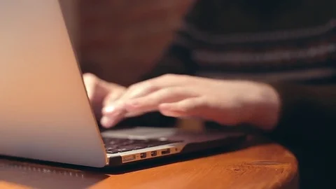 Man browsing in cafe on mobile computer typing keyboard massage on pc laptop Stock Footage 76562149