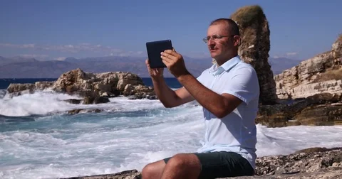Man Browsing Digital Tablet Vacation Outdoor Office Work Sea Coast Shoreline Day Stock Footage 70686969