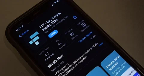 Man browsing FTX app (FTX Cryptocurrency Exchange) introduction in App Store Stock Footage 221123810