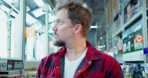 Man Browsing in Hardware Store Aisle Stock Footage 323780075