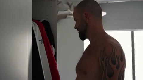 Man browsing his wardrobe picking clothes to wear Stock Footage 148540409