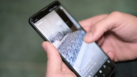Man browsing instagram app stories on a smartphone,social network addict,web Stock Footage 145115399