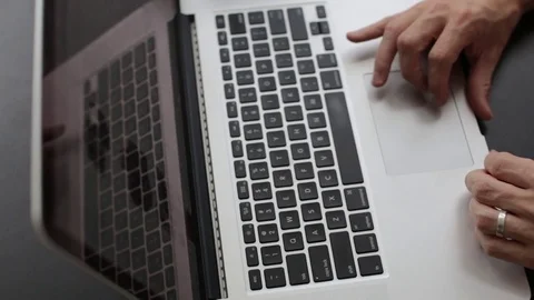 Man Browsing the Internet and Typing on Computer Stock Footage 76484132