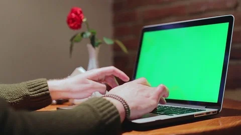 Man browsing in internet cafe, typing keyboard massage on laptop. Green screen Stock Footage 76563507
