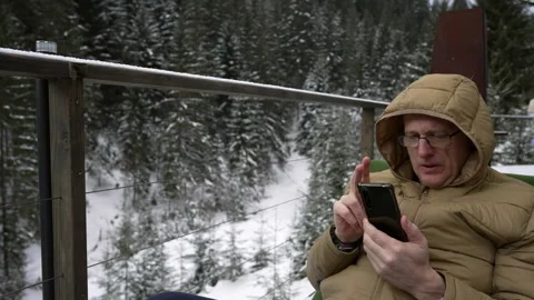 A man is browsing Internet content on his phone. Stock Footage 265173534